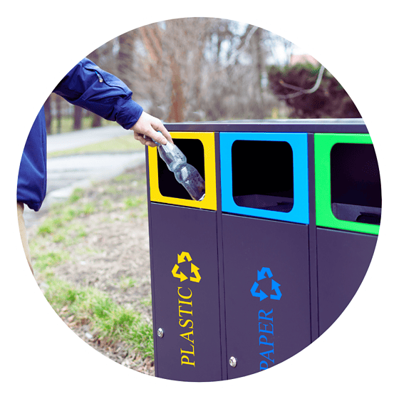 a person throwing a plastic bottle into a trash can