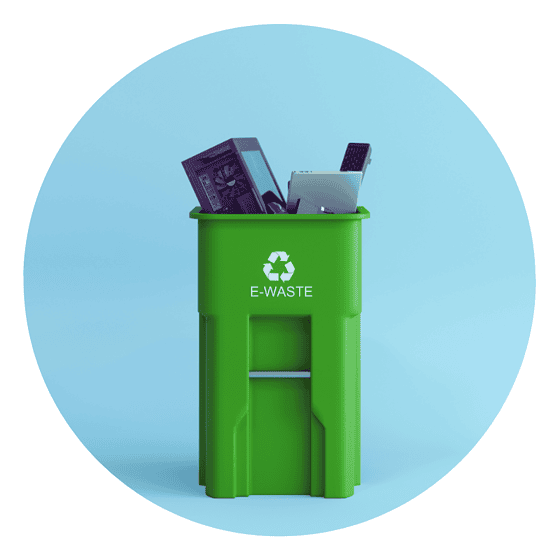 a green recycle bin with electronic devices in it